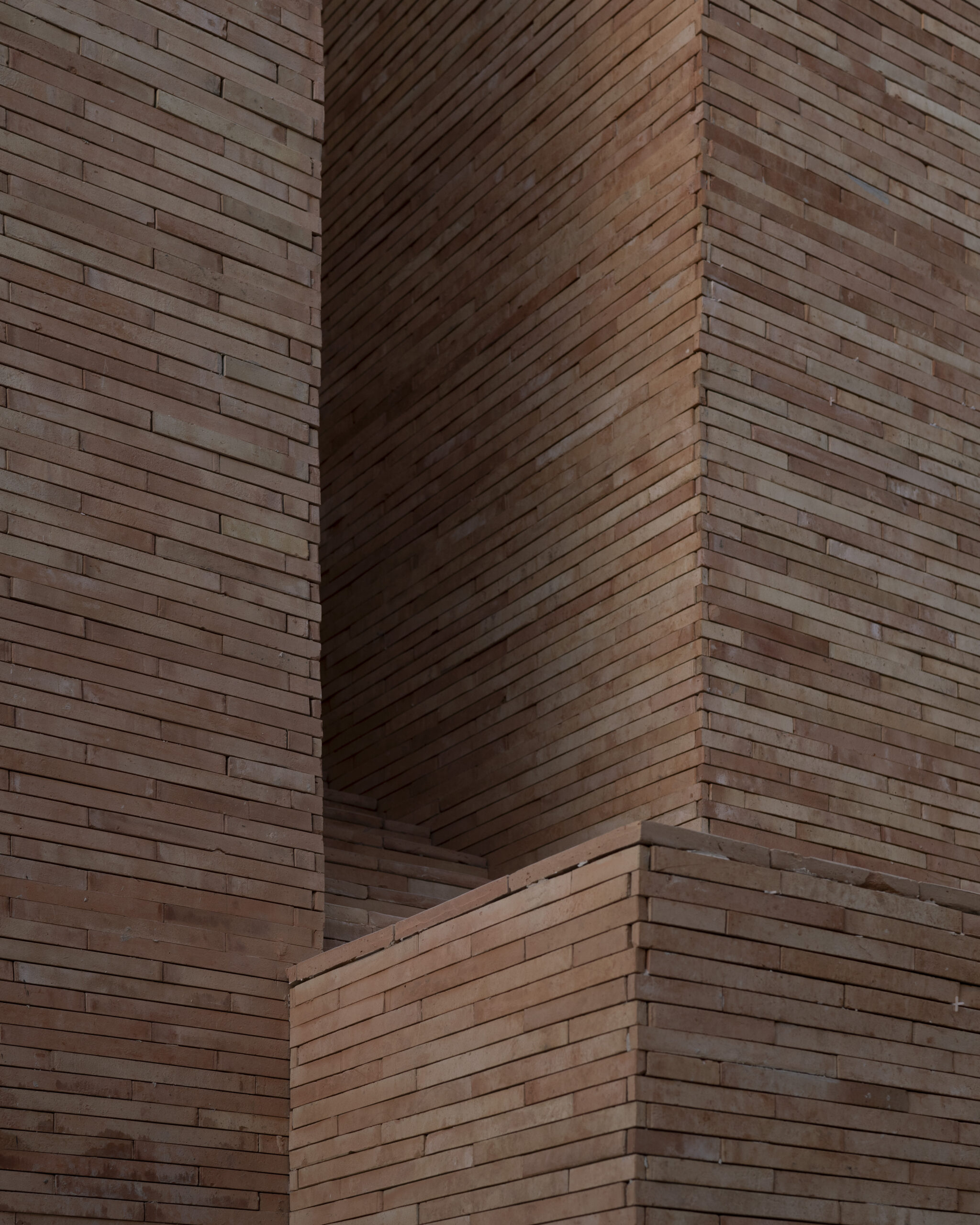 Close-up of handlaid brick façade detail at Ánima Village retail district, Los Cabos. By Sordo Madaleno.