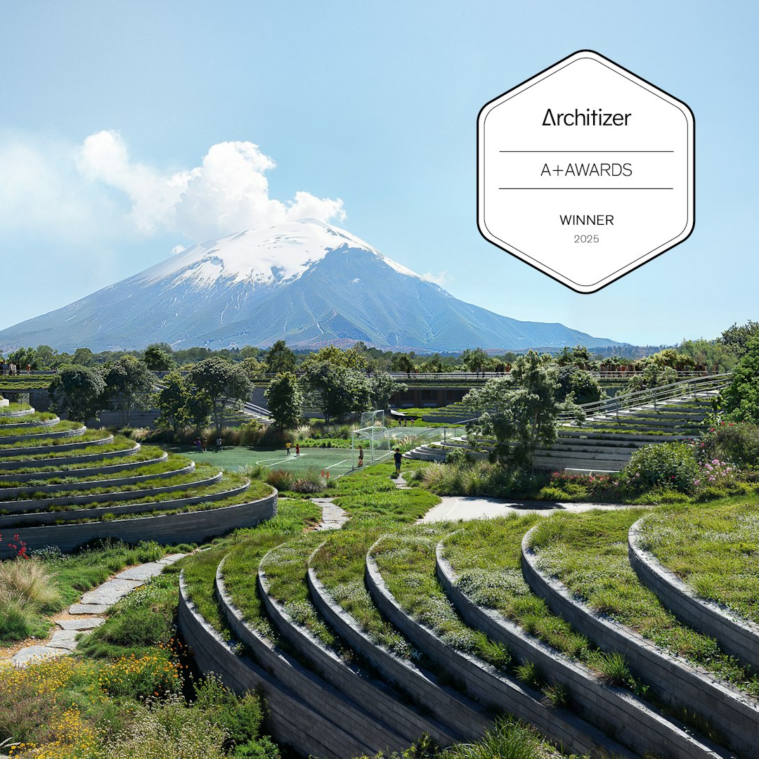 Render of terraced landscape and sports pitch at Canadian School, Cholula, with Popocatépetl volcano beyond. Architizer A+ Awards Winner 2025. By Sordo Madaleno.