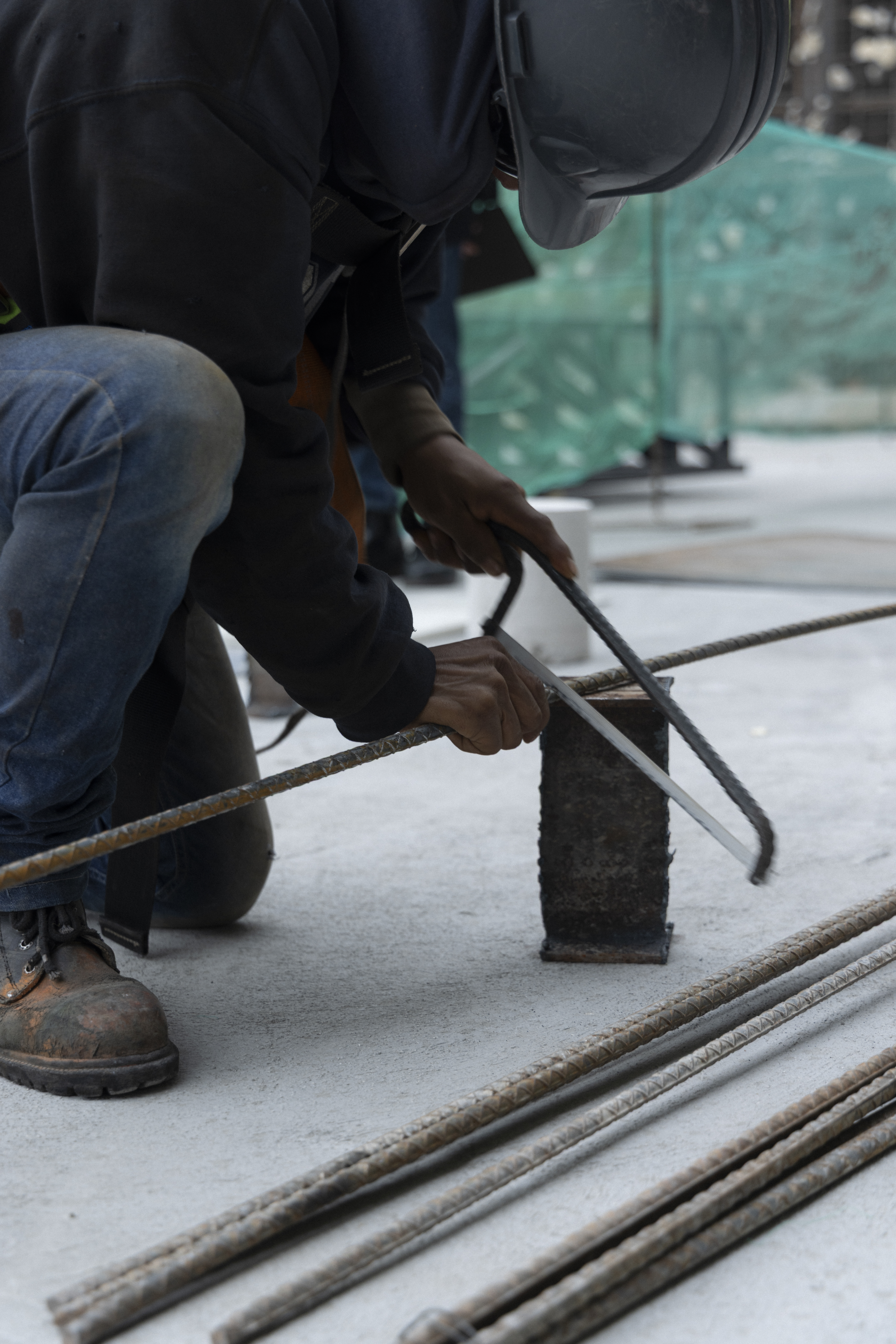 construction worker sawing rebar