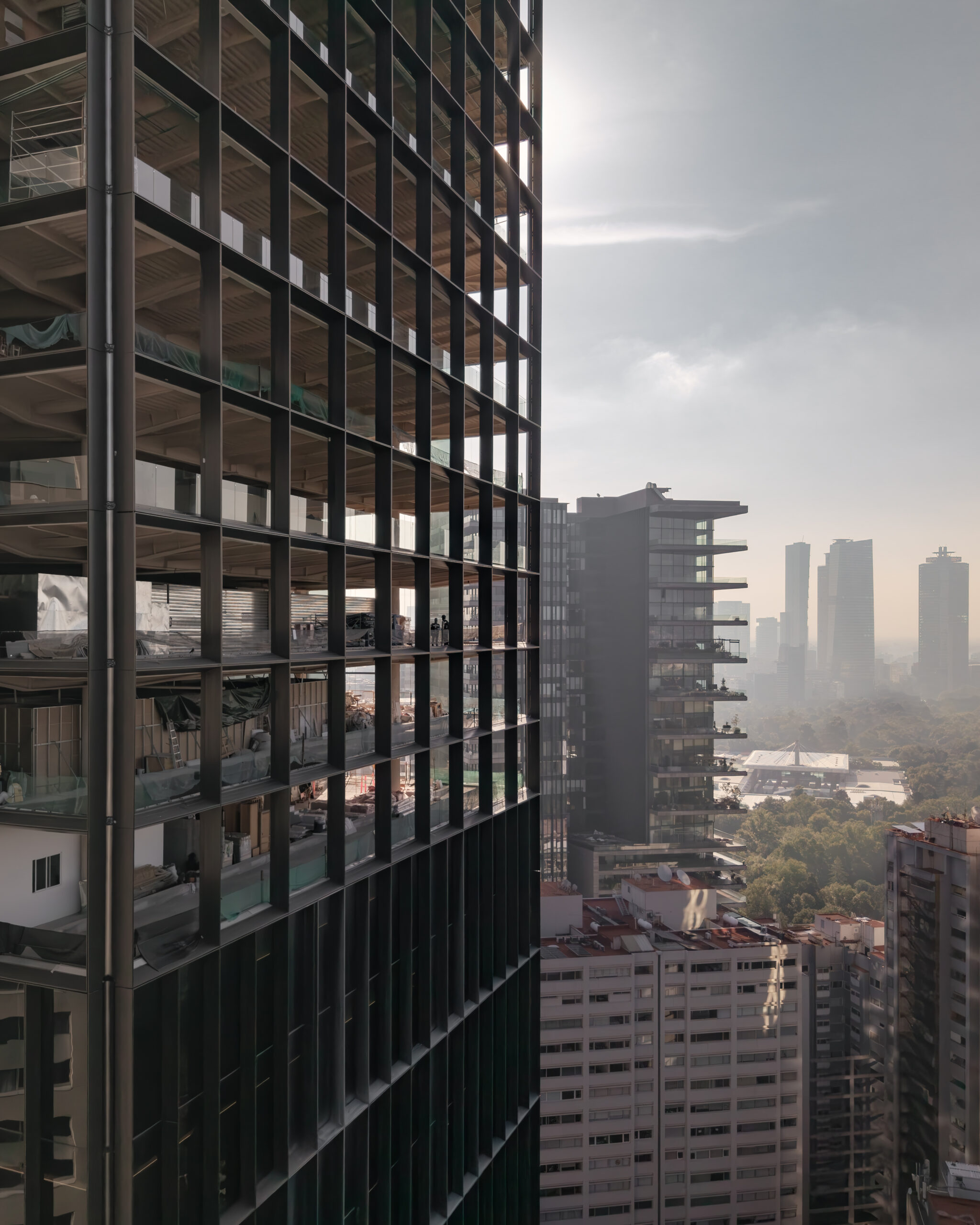 Close-up of Park Hyatt Mexico City facade grid under construction, overlooking Bosque de Chapultepec and CDMX.