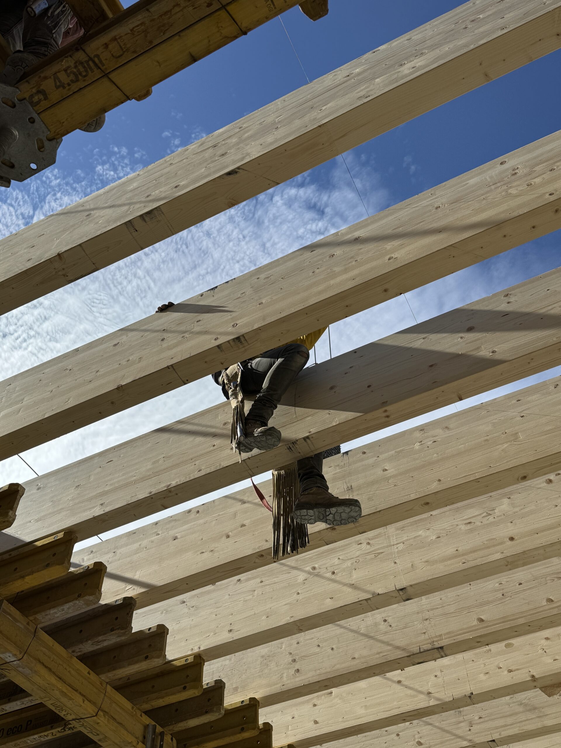 Glue-laminated timber beam grid during construction — Corporativo SOMA